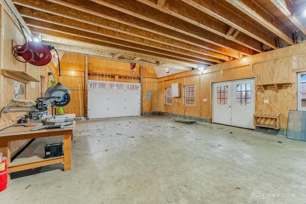 7400 Cook-Jones Road Waynesville, OH 45068 - Photo 61 of 72 This spacious garage offers ample room for vehicles and projects, featuring exposed beam ceilings.
