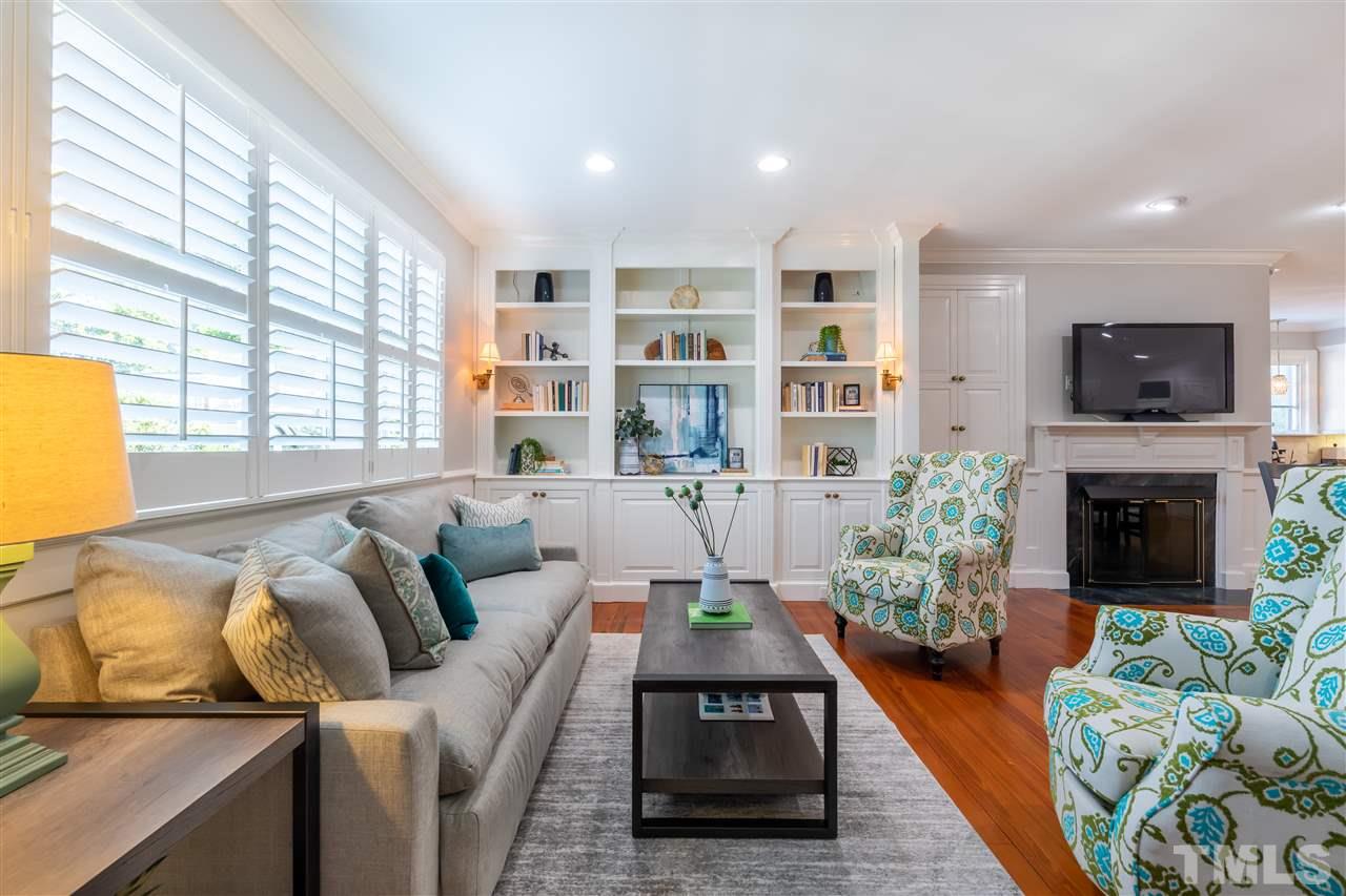 1110 Harvey Street Raleigh, NC 27608 - Photo 8 of 30 The family room has a fireplace and stunning built-in shelving.