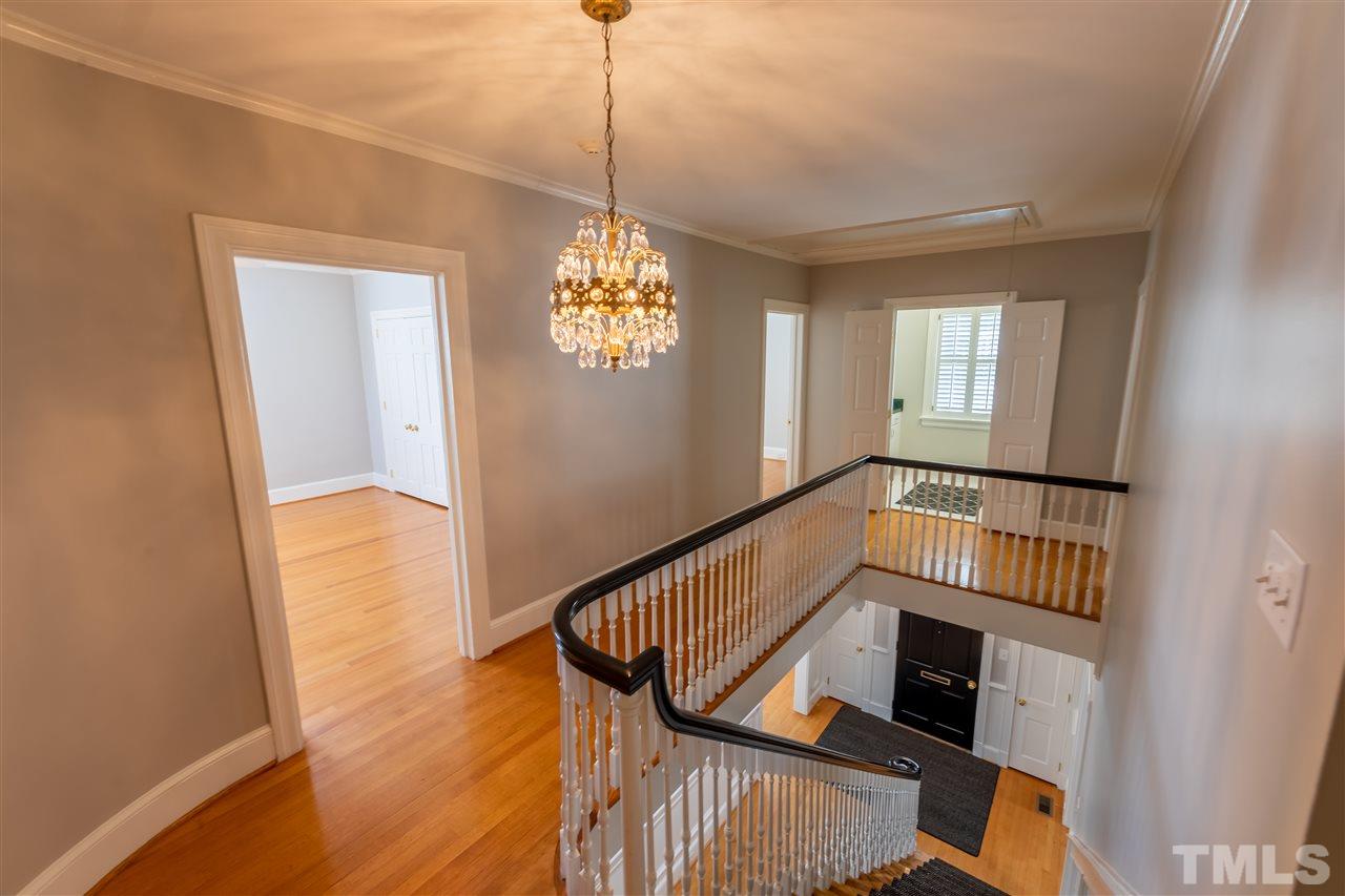 1110 Harvey Street Raleigh, NC 27608 - Photo 10 of 30 Stunning stairwell with elegant banister and lighting leads up to the spacious second level.