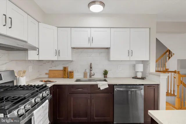 a kitchen with stainless steel appliances a refrigerator sink and cabinets