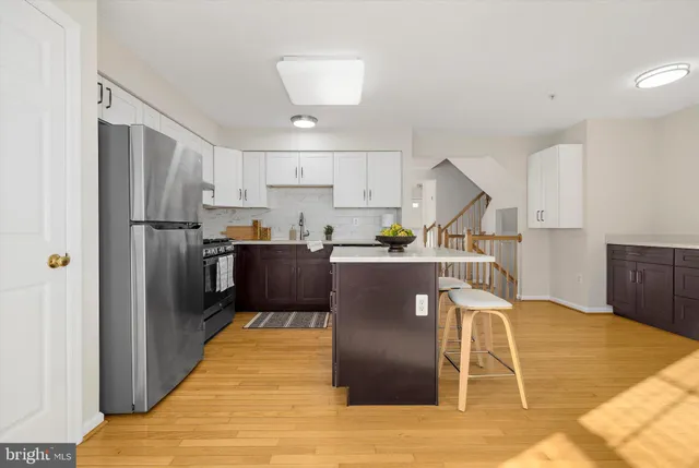 a kitchen with granite countertop a sink a stove and cabinets