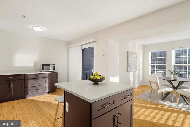 a kitchen with stainless steel appliances kitchen island granite countertop a refrigerator a stove and a sink