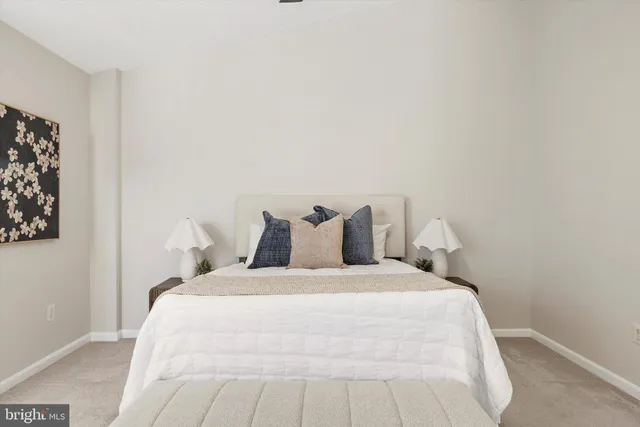 a large bed sitting in a bedroom next to a white wall