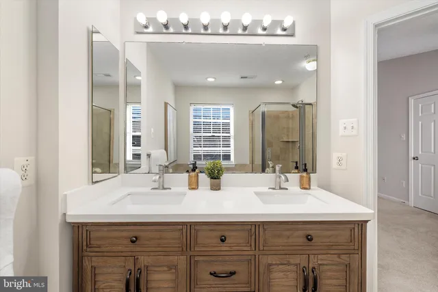 a bathroom with a sink double vanity and a mirror