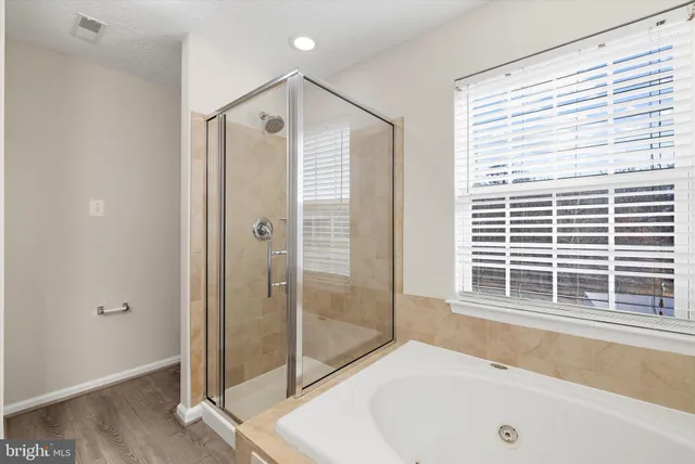 a bathroom with a bathtub and a shower