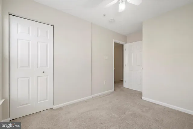 an empty room with a ceiling fan
