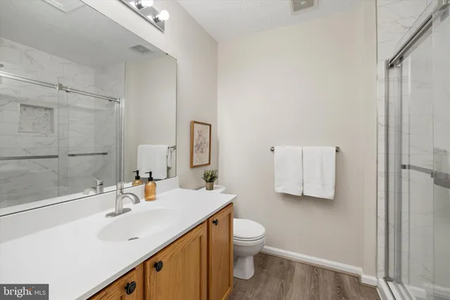a bathroom with a sink toilet and shower