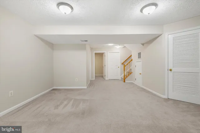 a view of empty room with a fireplace