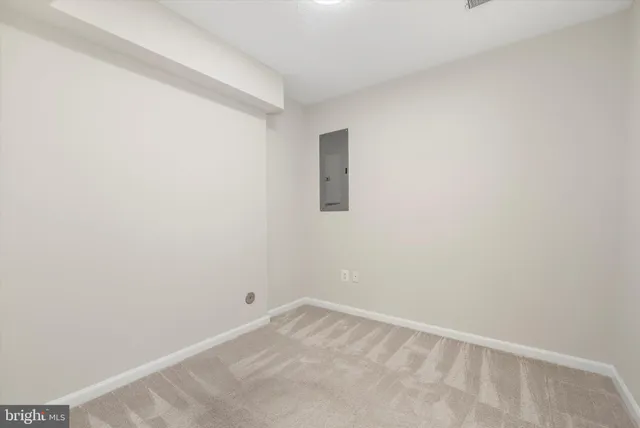 a view of an empty room with a fireplace