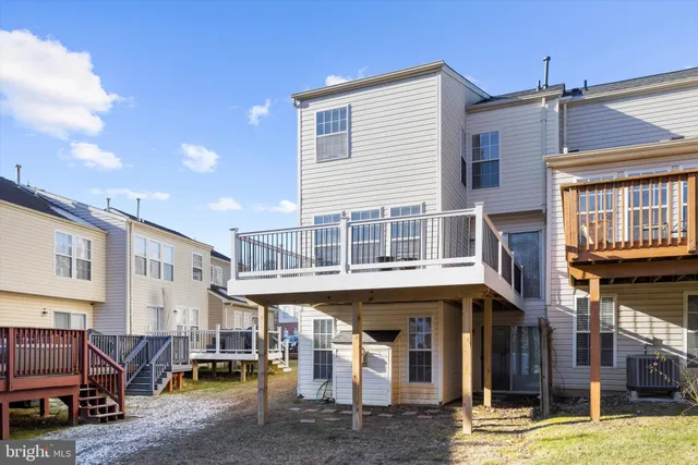 a view of roof deck with chairs and wooden fence
