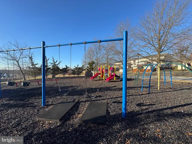 an outdoor space with seating area and trees