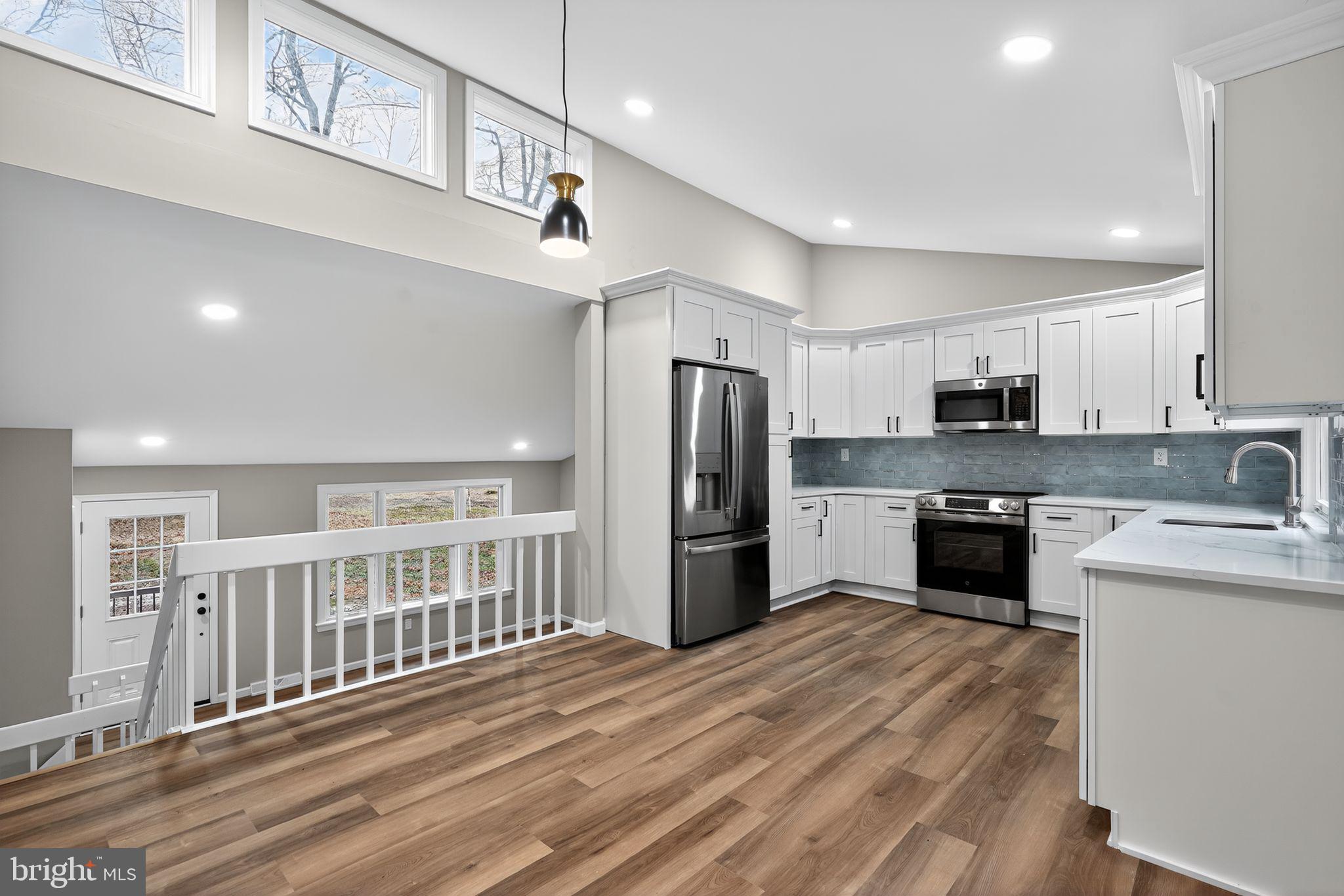 120 Gilbert Road Bordentown, NJ 08505 - Photo 17 of 52 a kitchen with stainless steel appliances granite countertop a refrigerator a sink dishwasher a stove and a refrigerator with wooden floor