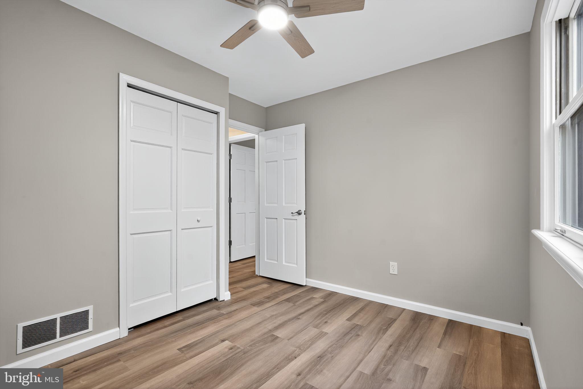 120 Gilbert Road Bordentown, NJ 08505 - Photo 26 of 52 an empty room with wooden floor cabinet and windows