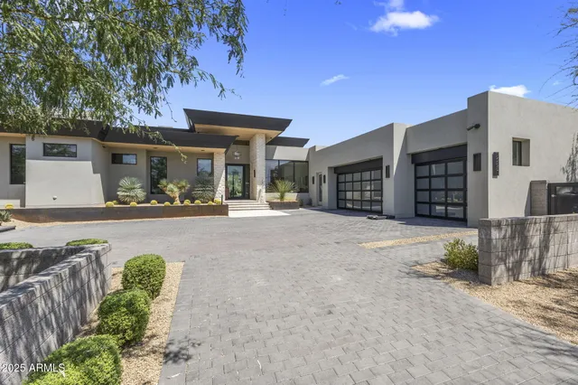 a view of a house with a yard and garage