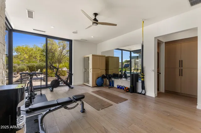 a room with gym equipment and a large window