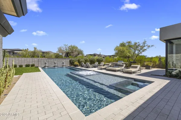 a view of swimming pool with sitting area