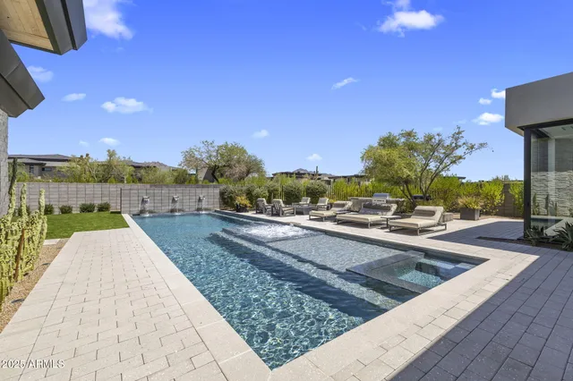 a view of swimming pool with sitting area