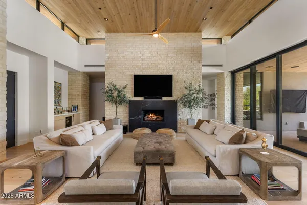 a living room with furniture fireplace and a flat screen tv