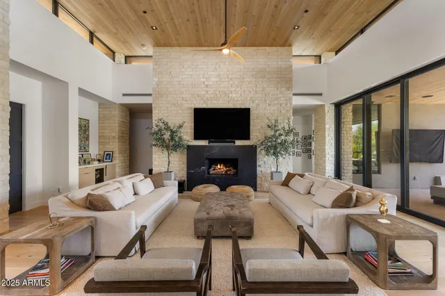 a living room with furniture fireplace and a flat screen tv