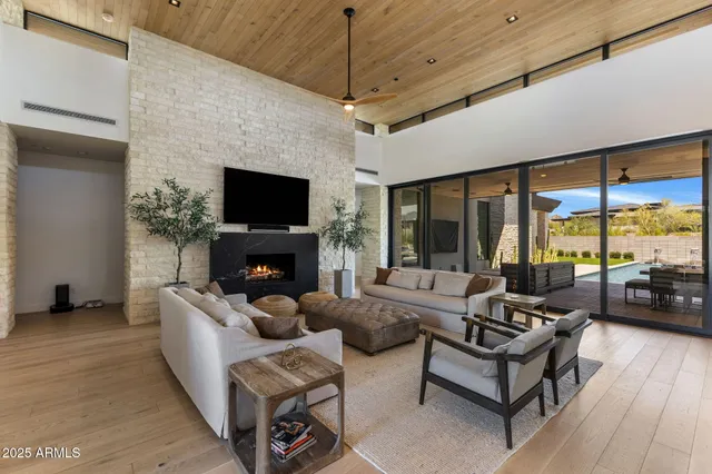 a living room with furniture a flat screen tv and a fireplace