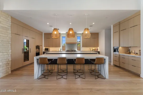 a kitchen with a sink cabinets and dining table chair