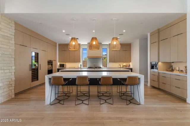 a kitchen with a sink cabinets and dining table chair