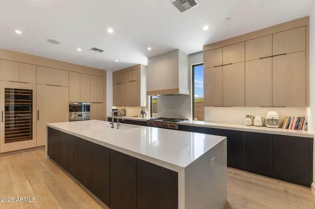 a kitchen with stainless steel appliances a sink stove and cabinets