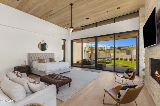 a bedroom with furniture and a large window