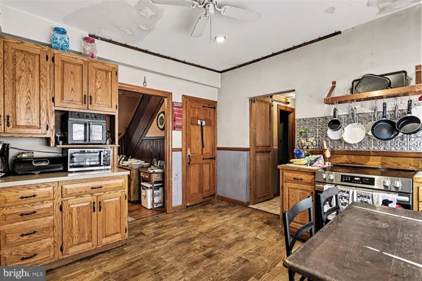 a kitchen with stainless steel appliances granite countertop a stove refrigerator and cabinets