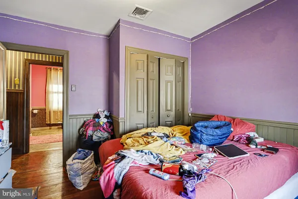 a bed sitting in a bedroom next to a window