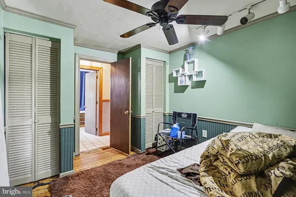 a bedroom with a bed and a chandelier
