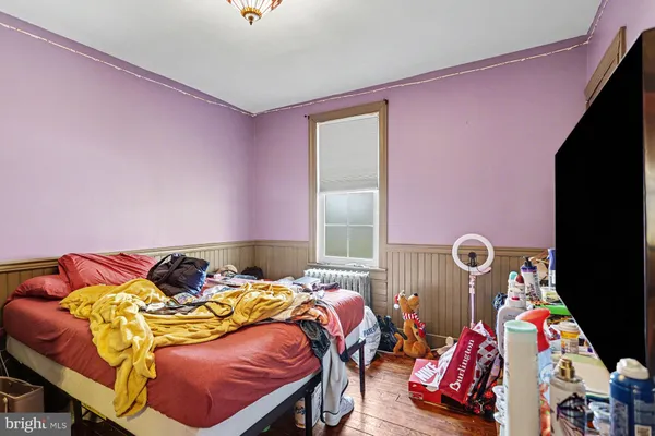 a bed sitting in a bedroom next to a window