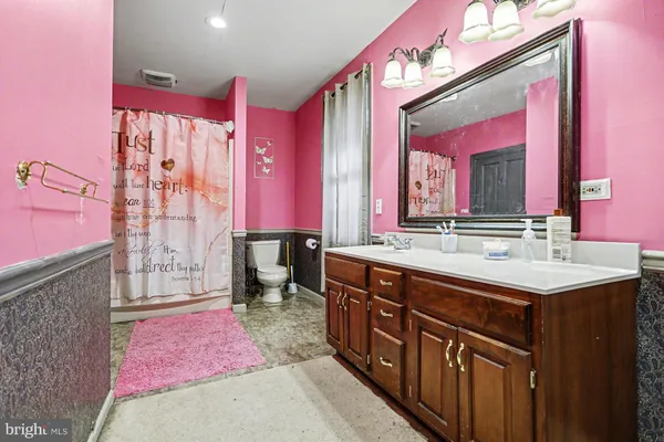 a spacious bathroom with a sink vanity and a mirror