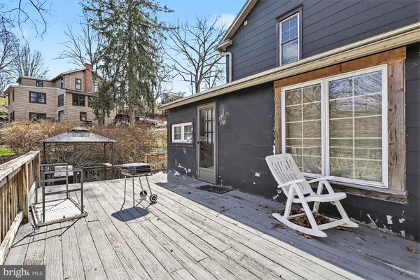 a view of a patio with table and chairs and wooden floor