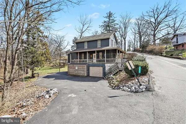 a view of a house with a yard and garage