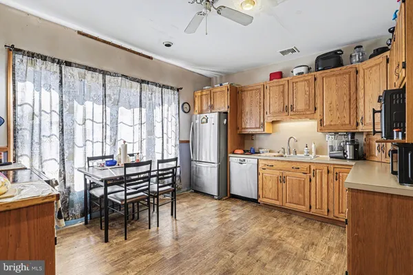 a kitchen with refrigerator cabinets and wooden floor