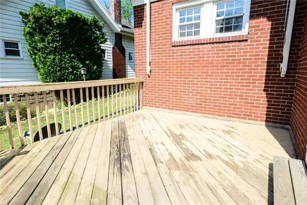 a view of a balcony with wooden floor
