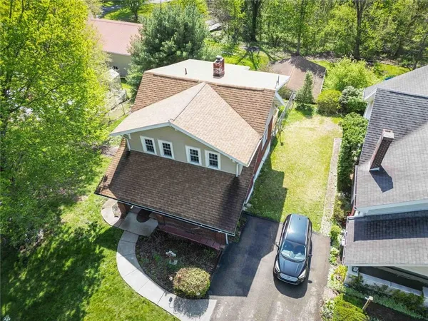 an aerial view of a house with swimming pool garden and patio