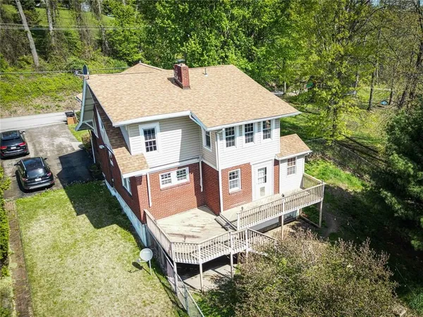 an aerial view of a house with a yard table and chairs