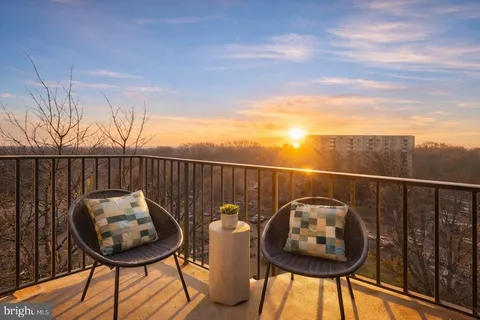 a view of a chairs and table on the roof deck