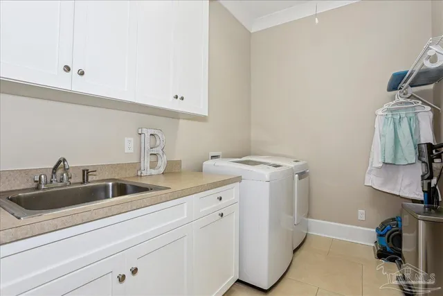 a kitchen with a sink and a stove with wooden floor