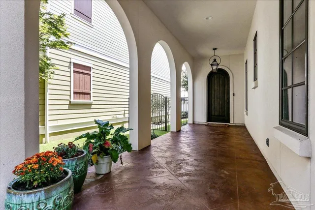 a view of a porch with potted plants