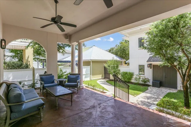 a living room with patio furniture and a floor to ceiling window