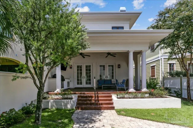 a view of a house with street and tree