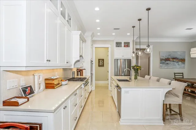 a kitchen with a sink appliances and cabinets