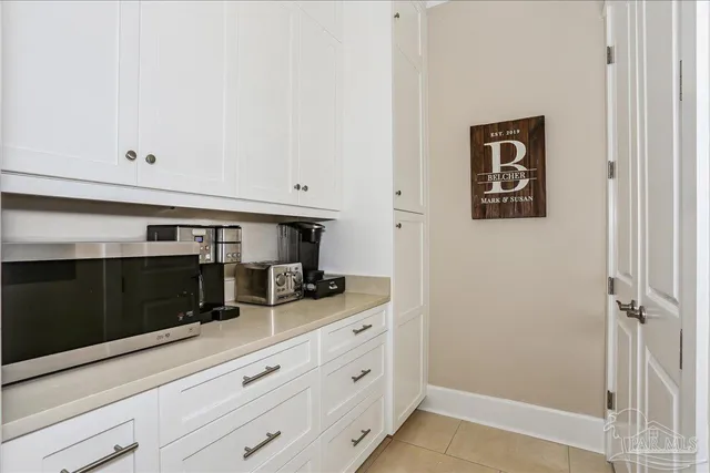 a kitchen with a refrigerator and cabinets