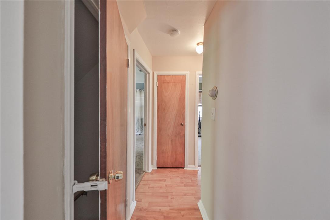 3050 Cornwall Road Bethlehem, PA 18017 - Photo 13 of 80 A well-lit hallway with natural wood doors and inviting laminate flooring awaits.