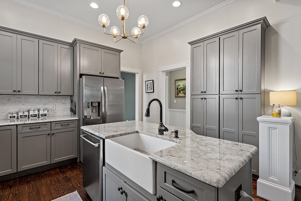 424 East Jones Street Raleigh, NC 27601 - Photo 11 of 27 a kitchen with stainless steel appliances granite countertop a sink refrigerator and cabinets