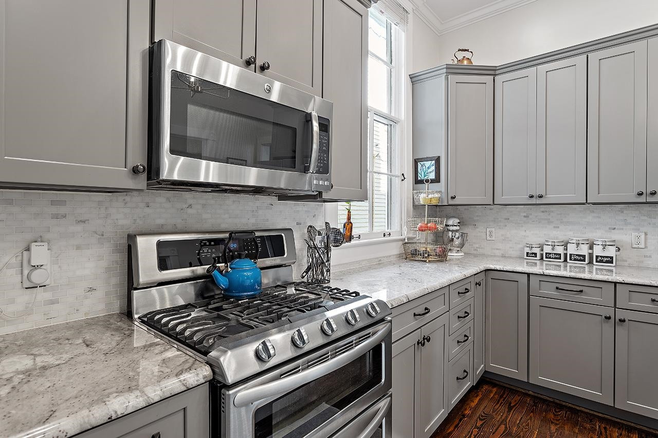 424 East Jones Street Raleigh, NC 27601 - Photo 12 of 27 a kitchen with stainless steel appliances a sink a stove and cabinets