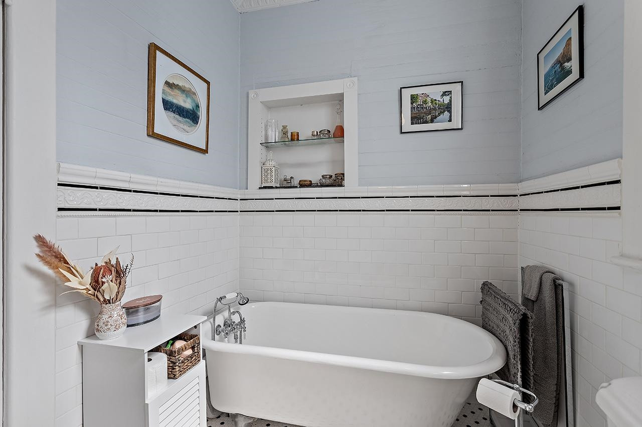 424 East Jones Street Raleigh, NC 27601 - Photo 15 of 27 a bath tub sitting next to a white toilet and sink